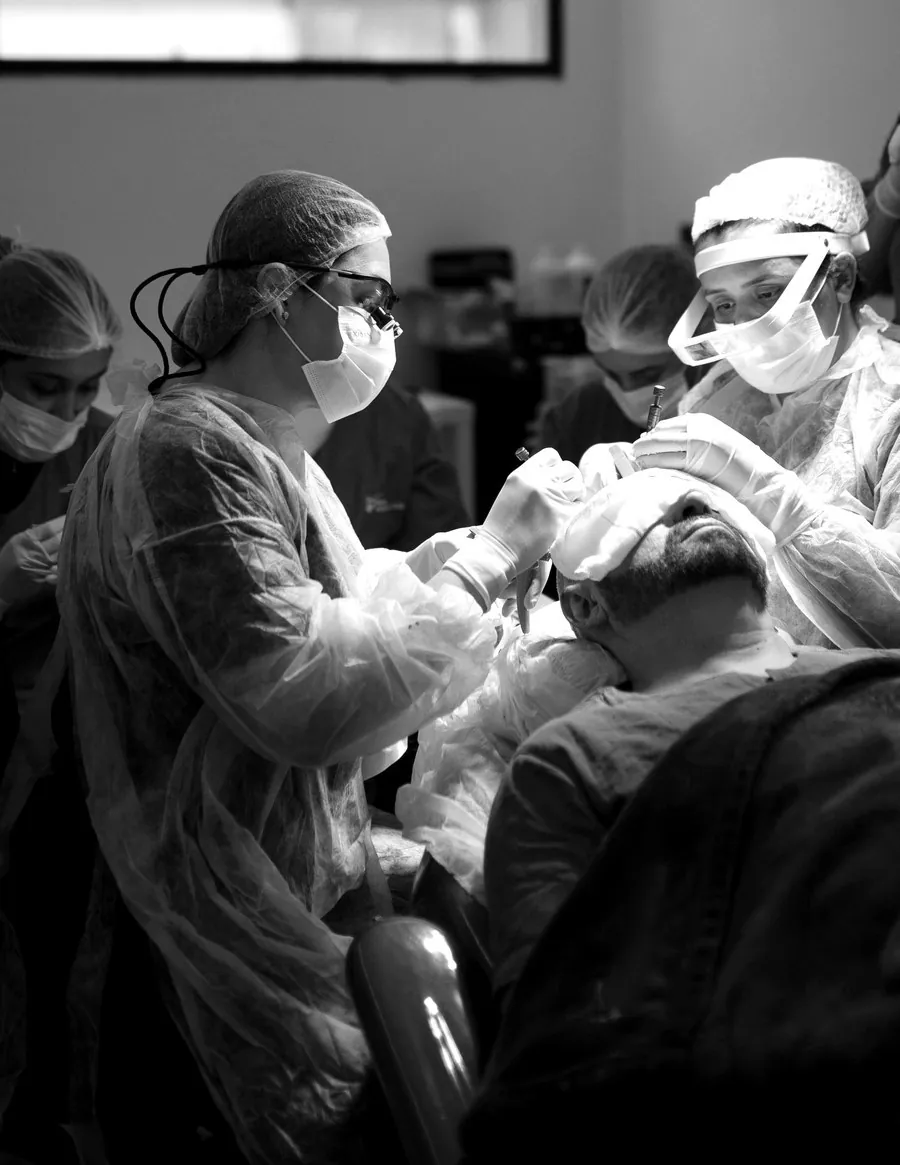 Female surgeon performing a hair transplant
