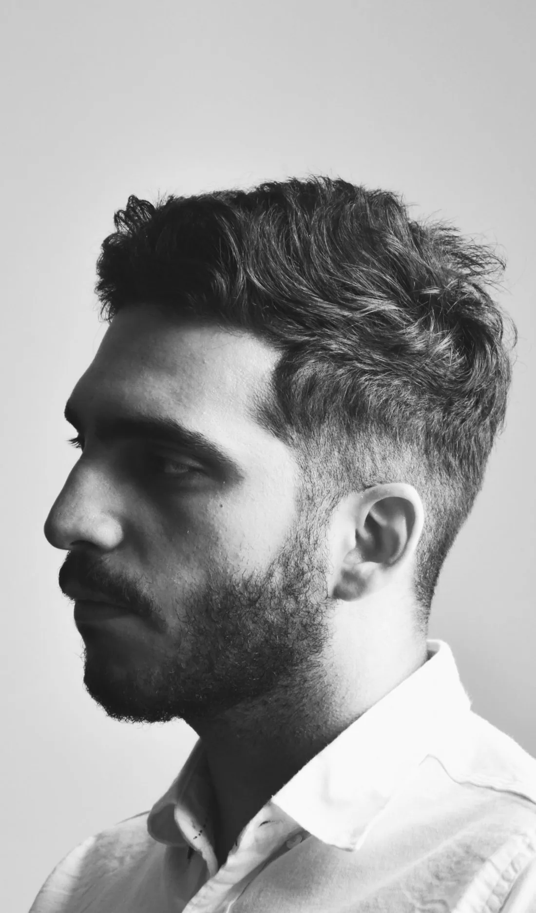 Profile portrait of a man with full, natural hair